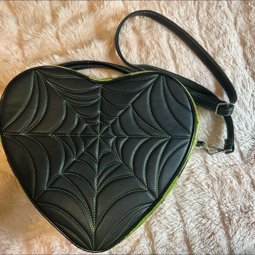 Love Pain and Stitches green and black crossbody/backpack